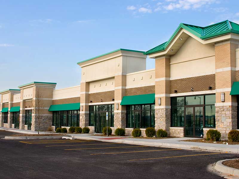 newly built strip mall building and parking lot.
